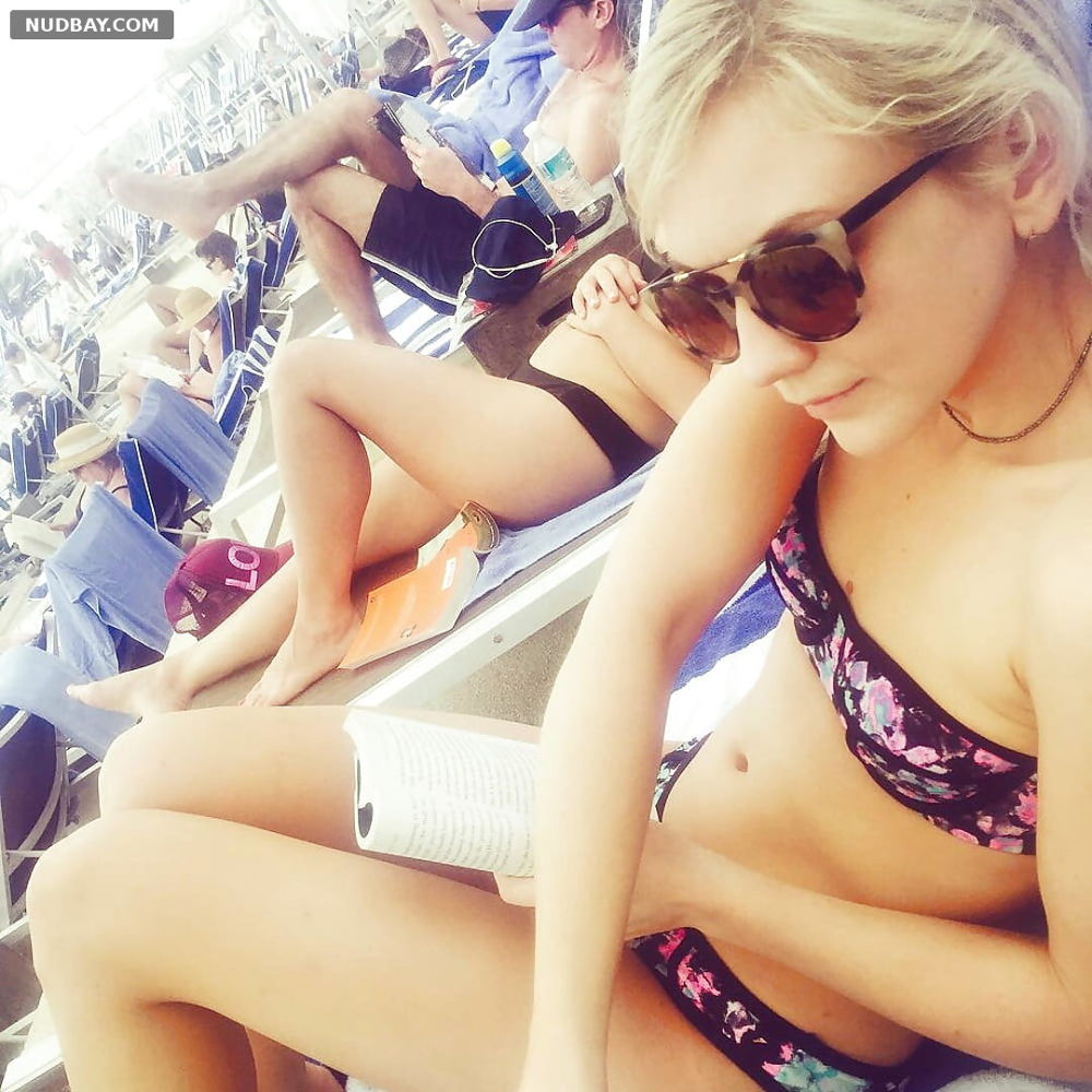Emily Kinney relaxing on the beach in a tiny bikini 2022